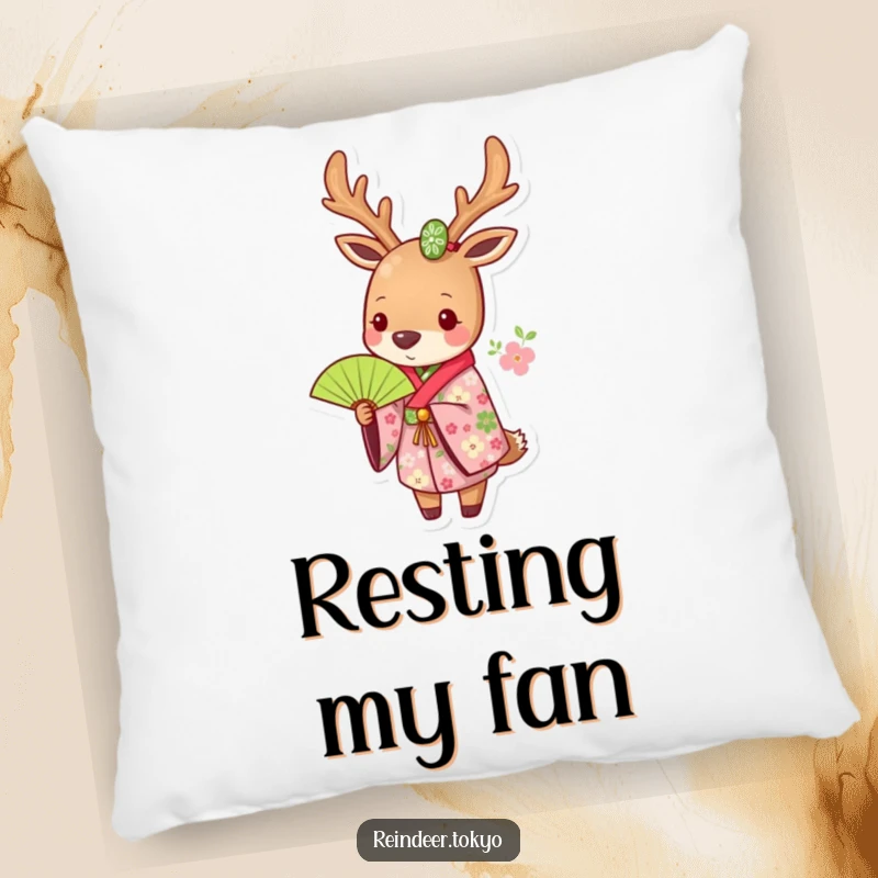 Funny pillow featuring a reindeer in a floral kimono, holding a green fan, offering decorative comfort with an artistic touch.