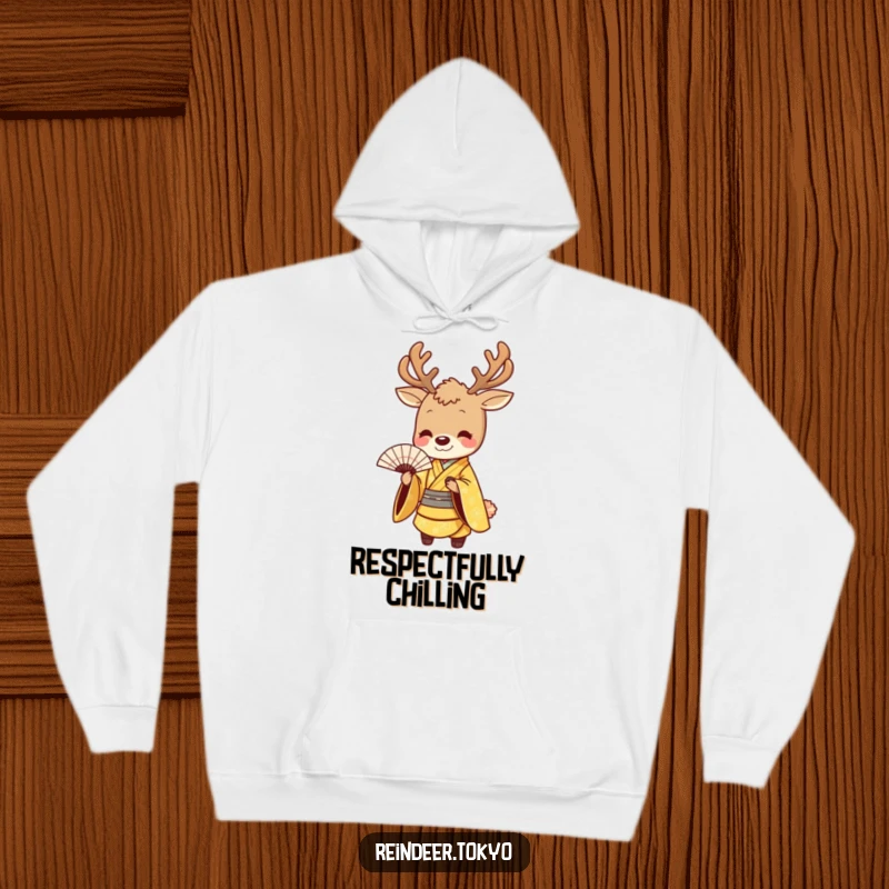 Funny hoodie depicting a smiling reindeer in a golden kimono, executing a graceful bow with a fan, combines warmth with polished humor.