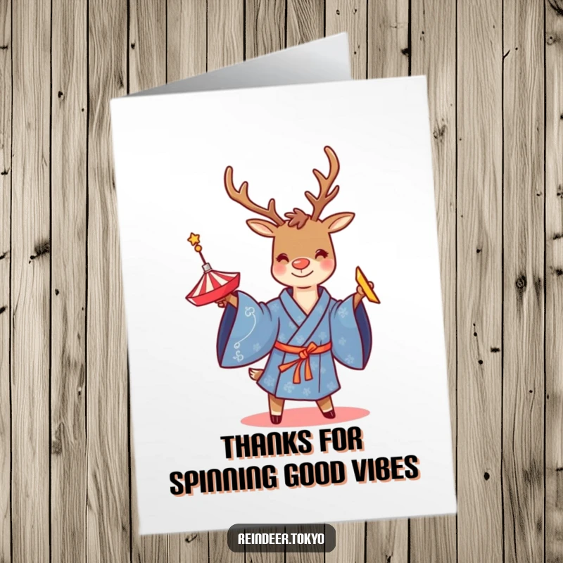 Funny free printable thank you card featuring a reindeer in a blue kimono, smiling while twirling a top.