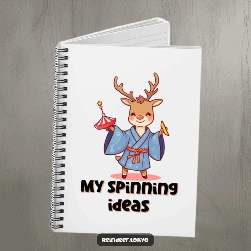 Funny notebook featuring a smiling reindeer in a blue kimono, twirling a spinning top, perfect for notes or creative writing.